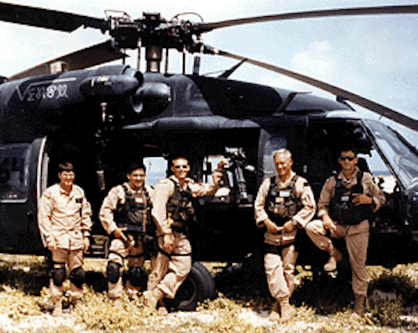 Winn Mahuron, Tommy Field, Bill Cleveland, Ray Frank and Mike Durant standing in front of the Black Hawk 'Super Sixty-Four'