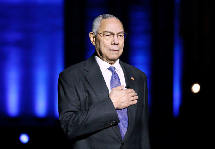 Colin Powell with his hand over his chest