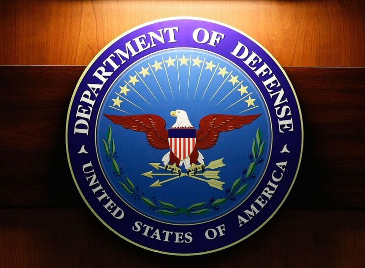 Seal of the US Department of Defense against a wooden backdrop