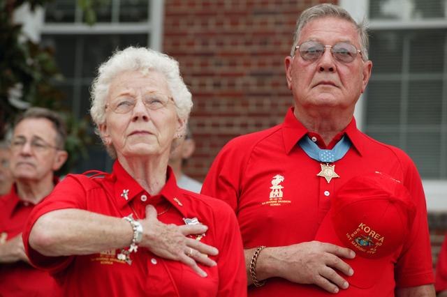 Bertha and Duane Dewey standing at attention