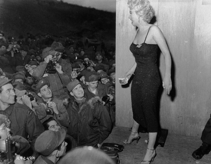 Marilyn Monroe staring out into a crowd of American troops