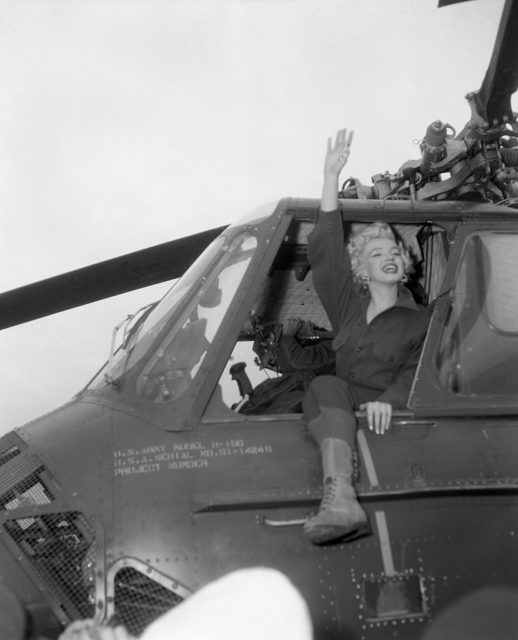 Marilyn Monroe waving out the window of a helicopter
