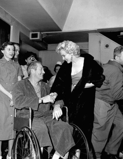 Marilyn Monroe smiling at Donald L. Wakehouse, who is sitting in a wheelchair