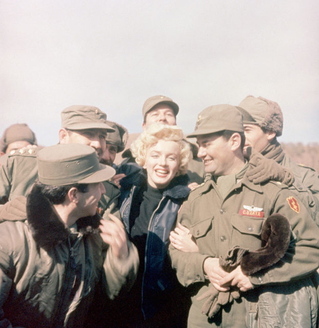 American troops standing around Marilyn Monroe