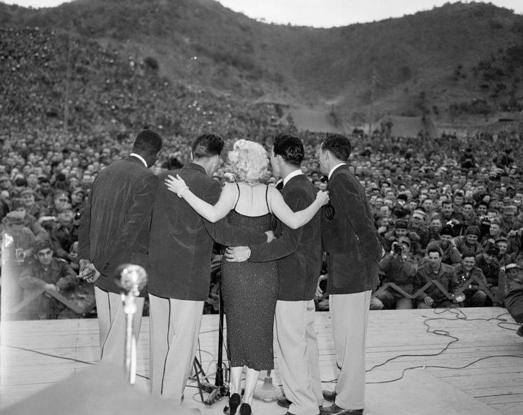 Marilyn Monroe embracing the members of Anything Goes onstage
