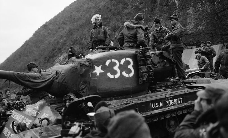 Marilyn Monroe sitting atop a military tank