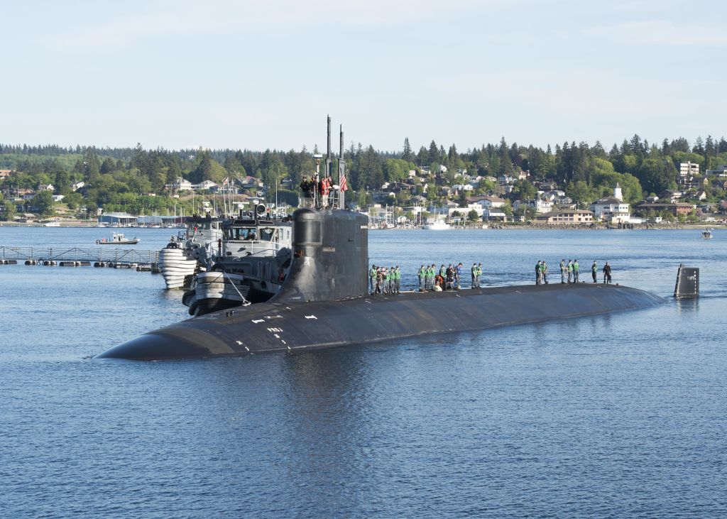 Photograph of submariners standing on top of the Seawolf-class fast-attack submarine USS Connecticut in the water at Naval Base Kitsap-Bremerton, Washington, May 7, 2018. (Photo Credit: Smith Collection/Gado/Getty Images)
