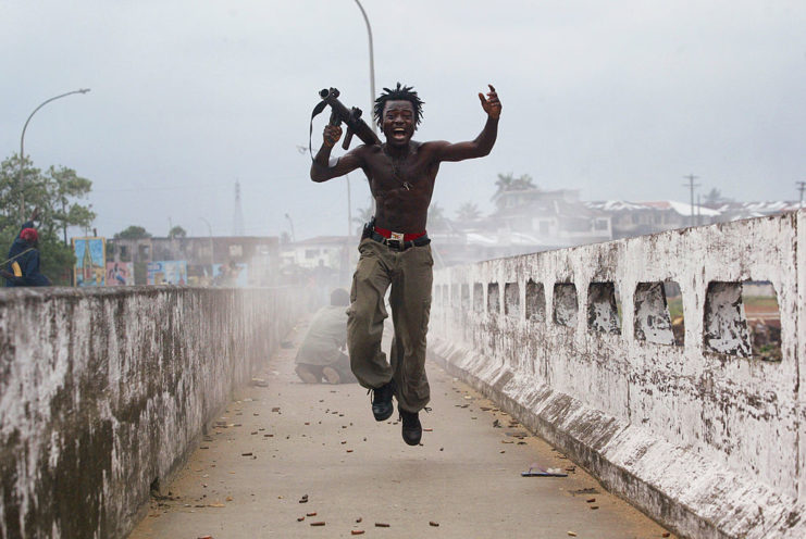 Joseph Duo jumping in the air while holding a grenade launcher