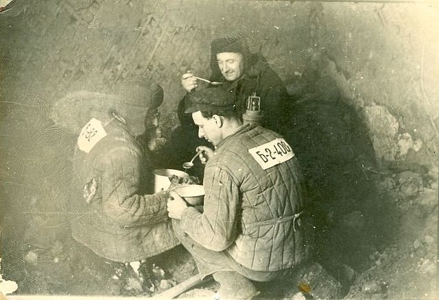 Three male prisoners eating lunch