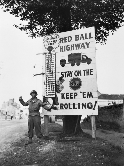 American soldier waves on a motor convoy