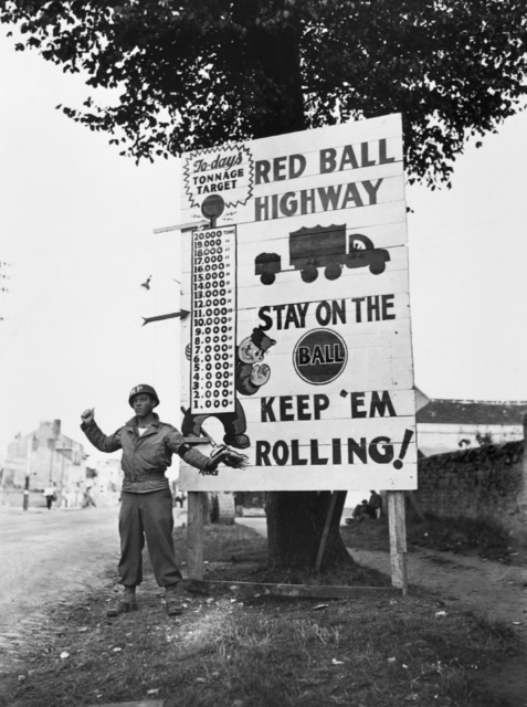 American soldier waves on a motor convoy 