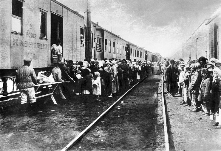 People standing around train cars