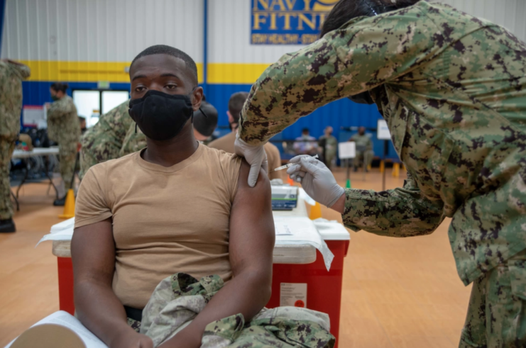 Male sailor being given the COVID-19 vaccine