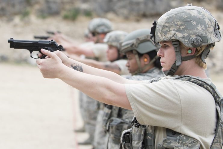 Air Force personnel aiming pistols