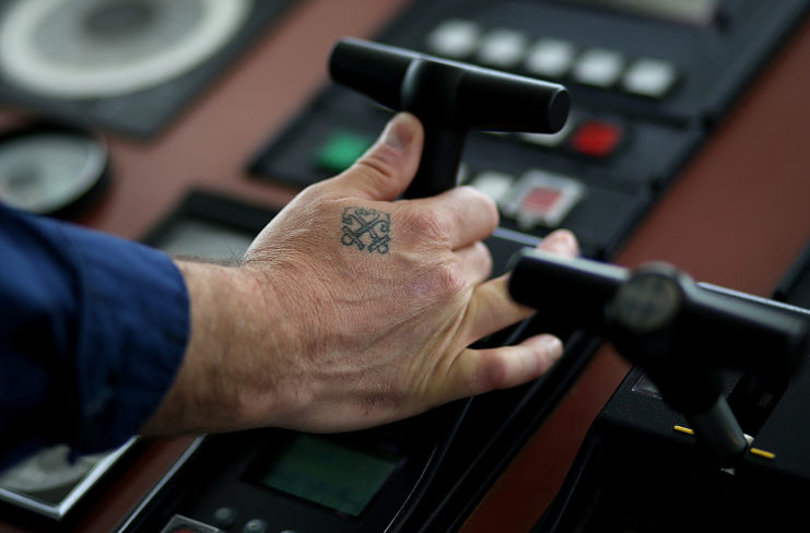 US Coast Guard crew member piloting a ship