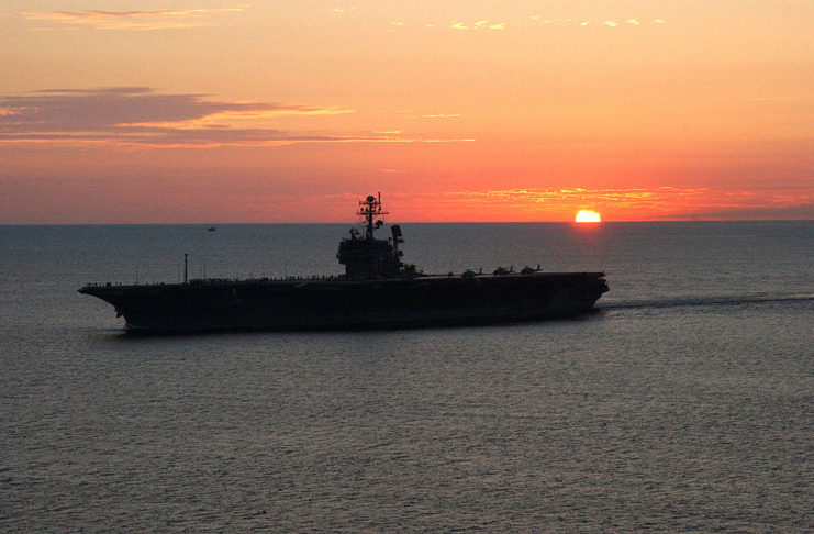 USS John F. Kennedy in the water at sunset