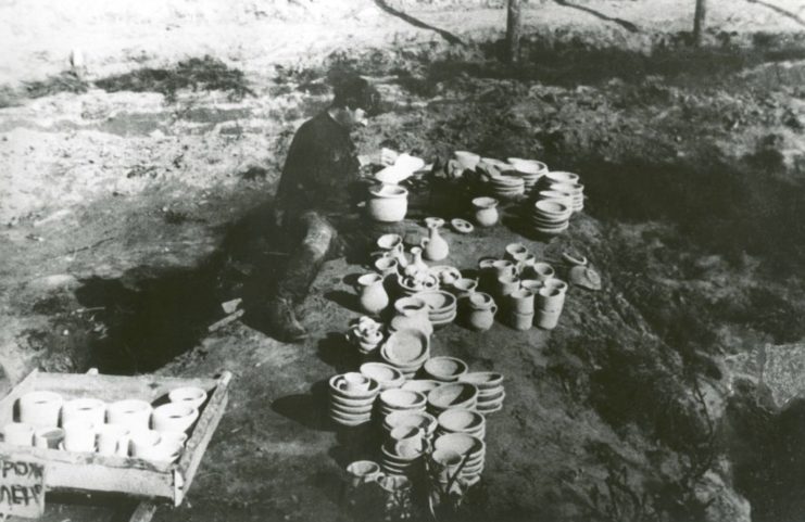 A male prisoner surrounded by pots