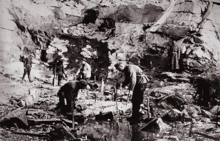 Male prisoners working in a rocky area