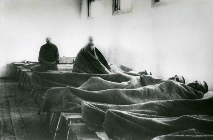 Male prisoners lying in hospital beds
