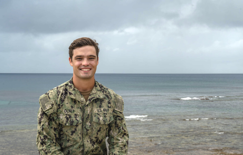 AEAN Ian Olney standing on a beach in uniform