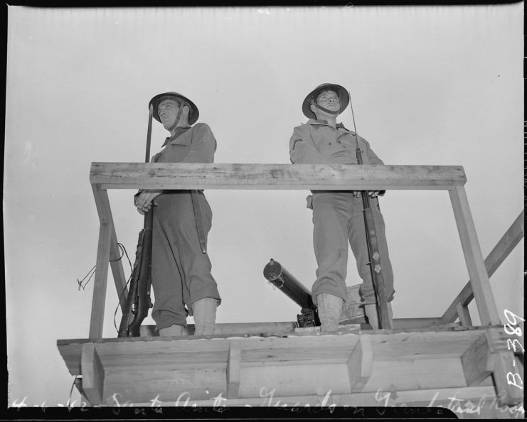 Two military police standing guard in a watch tower