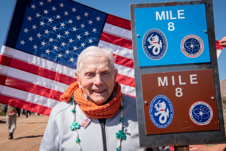 Ben Skardon standing at the Mile 8 marker of the Memorial Death March