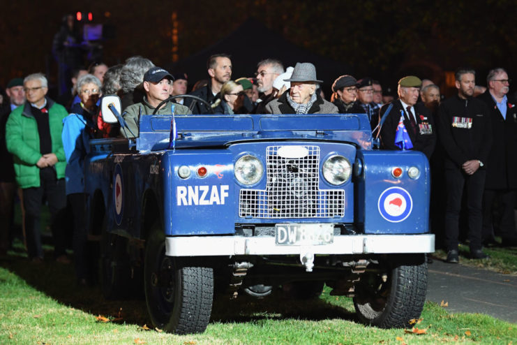 Bill Mitchell sitting in a blue Jeep with other individuals