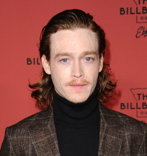 Caleb Landry Jones wearing a suit