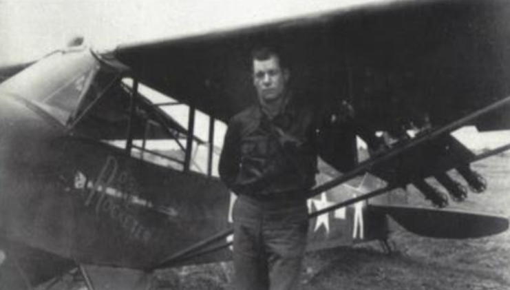 Charles Carpenter standing in front of his L-4 Grasshopper