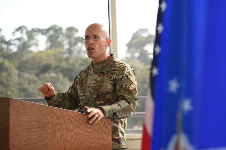 US Air Force Colonel Chance Geray speaking behind a podium