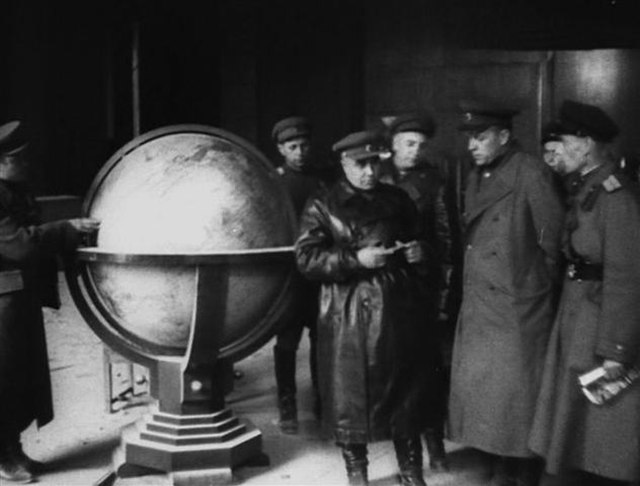 Soviet military officials standing beside the Columbus Globe for State and Industry Leaders