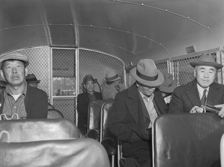 Japanese-American men sitting on a bus