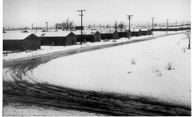 Snow-covered road and buildings at Manzanar War Relocation Center