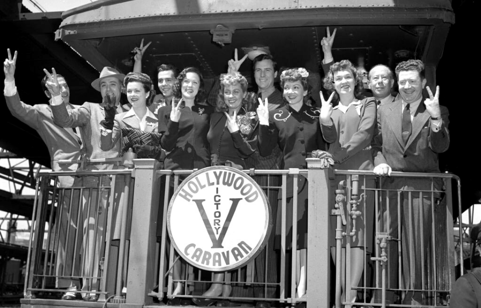 Members of the Hollywood Victory Caravan holding up "V" signs