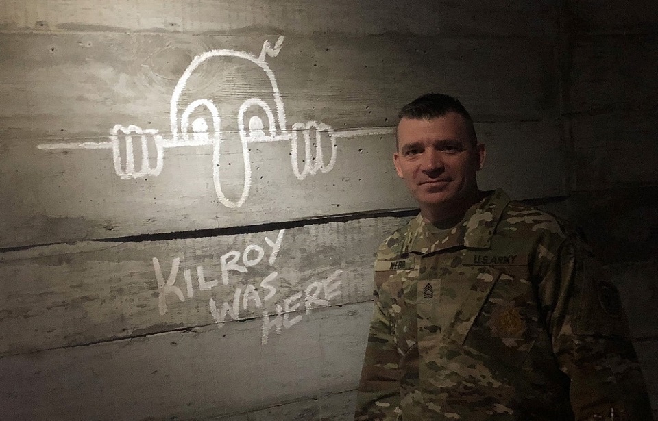 Master Sgt. Rick Webb, U.S. Army Recruiting Company – Warner Robbins (Georgia) poses with a “KILROY WA HERE” meme at the National World War II Museum in New Orleans, Louisiana, 27 June 2018. (Photo Credit: Nelson Ballew / U.S. Army 2nd Recruiting Brigade)