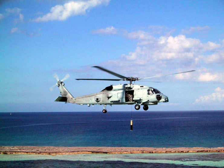Sikorsky MH-60R helicopter hovering above the ground