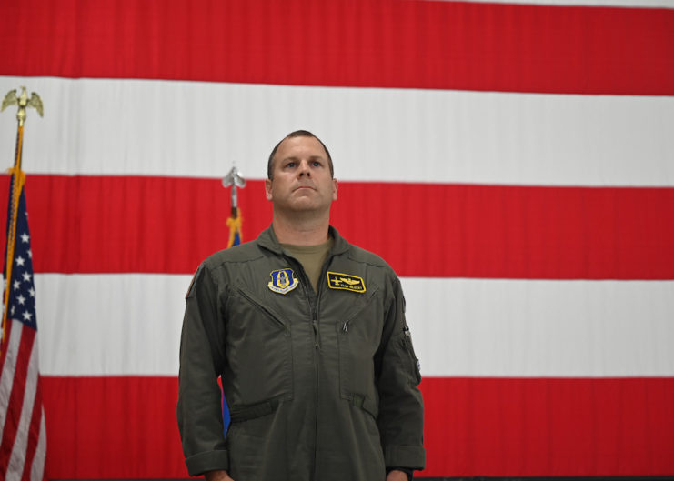 Mike "Vago" Hilkert standing in front of the American flag