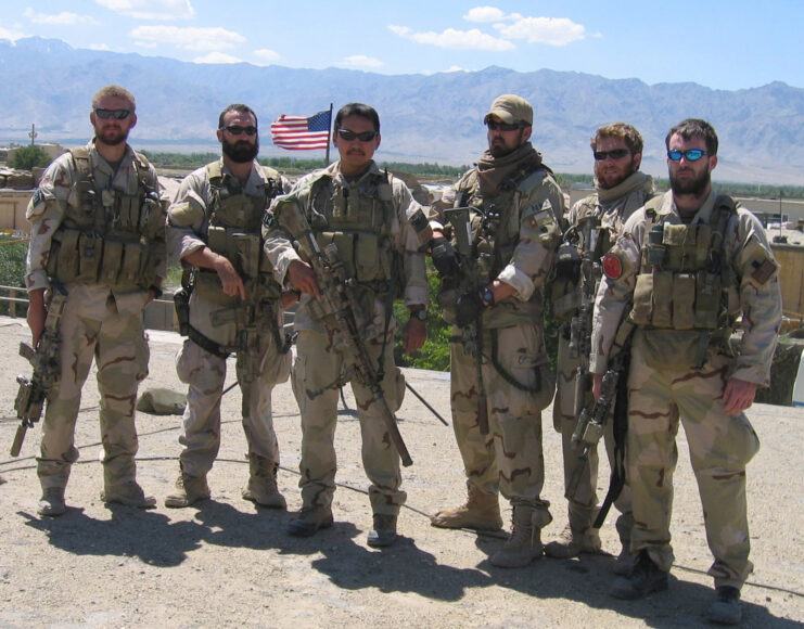Matthew Axelson, Daniel R. Healy, James Suh, Marcus Luttrell, Eric S. Patton and Michael P. Murphy standing together in uniform