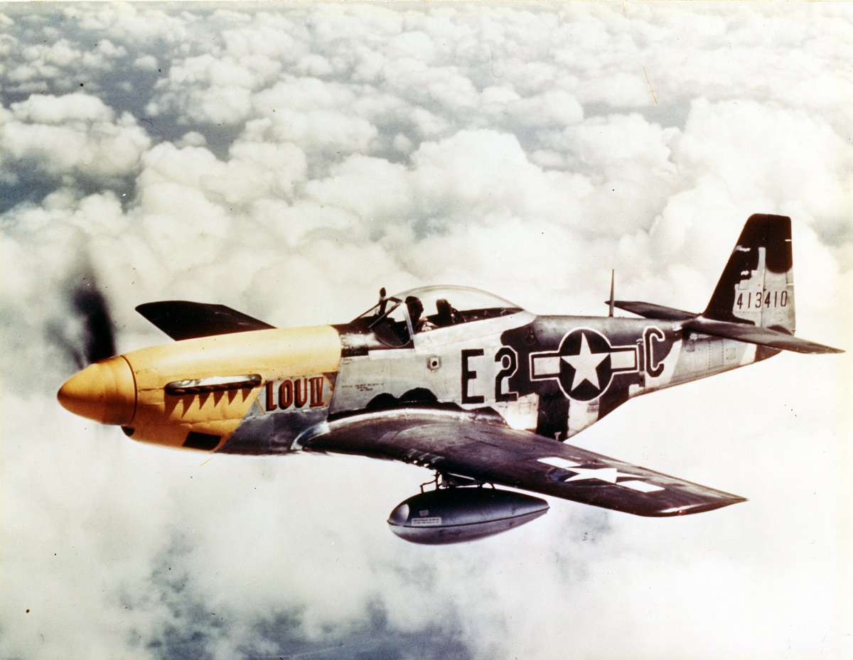 View of a North American P-51D Mustang of the 8th Air Force in flight over England, ca.1940s. Note the auxiliary fule tanks under the wing. (Photo by PhotoQuest/Getty Images)