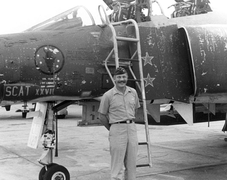 Robin Olds standing in front of the McDonnell Douglas F-4C Phantom II 'Scat XXVII'