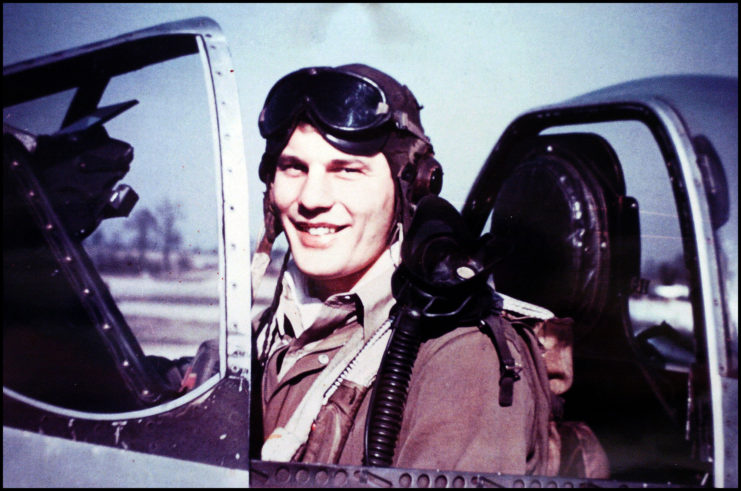 Robin Olds sitting in the cockpit of an aircraft