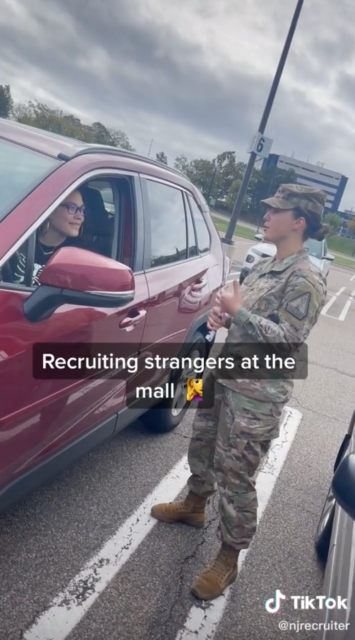 Sergeant Georgia Varoucha speaking to a woman who is sitting in a mini van