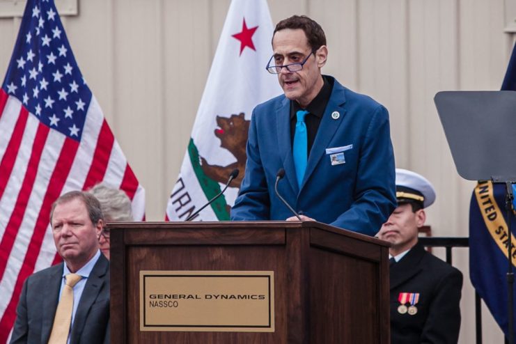 Stuart Milk standing behind a podium