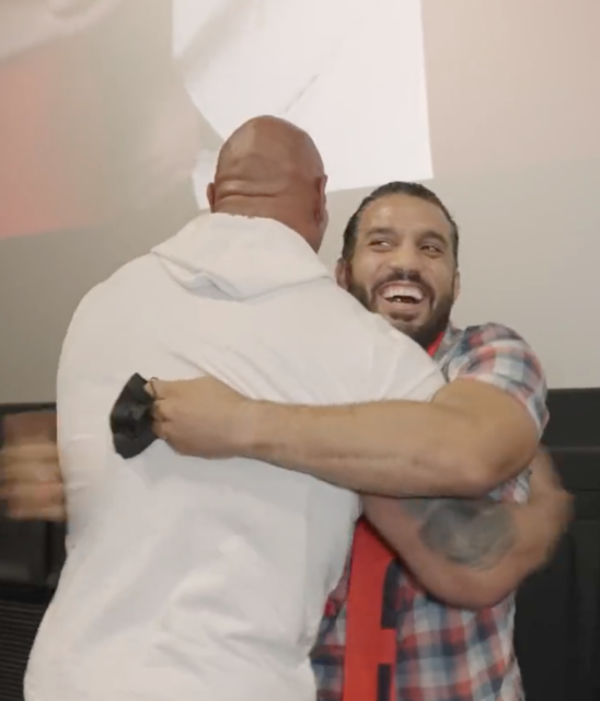 Dwayne "The Rock" Johnson hugging Oscar Rodriguez
