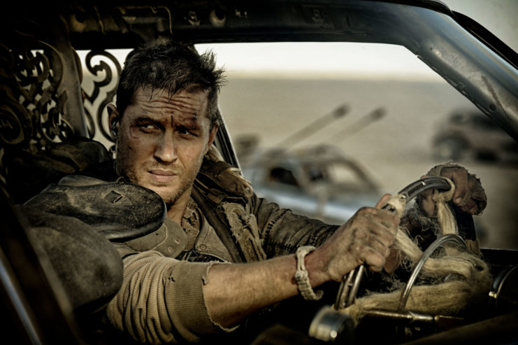 Max Rockatansky sitting behind the wheel of a car