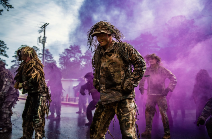 US Army Sniper School students standing in a pink and purple haze