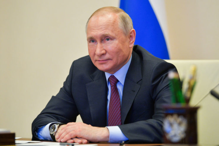 Vladimir Putin sitting at a desk