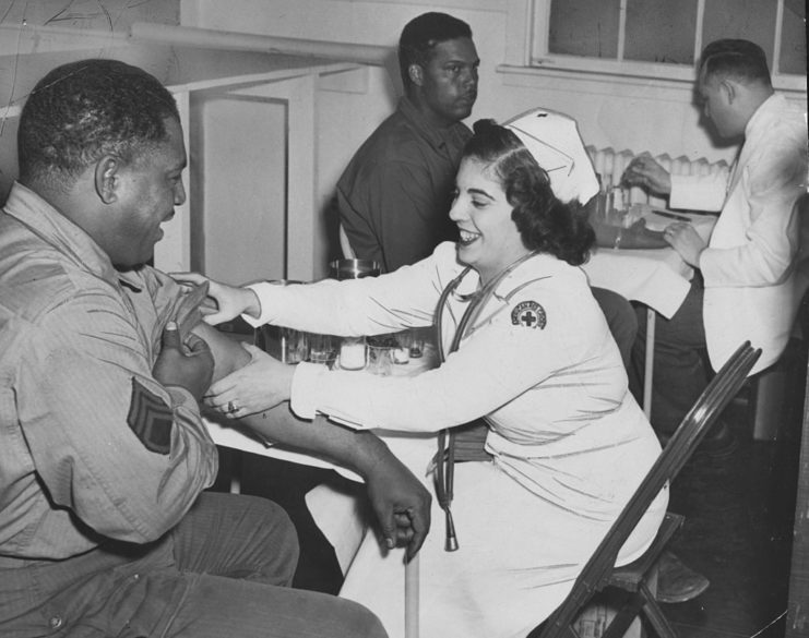 Two African-American men donating blood to the American Red Cross