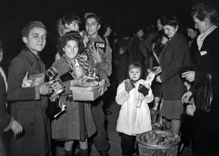 Parisian children standing with toys in their arms