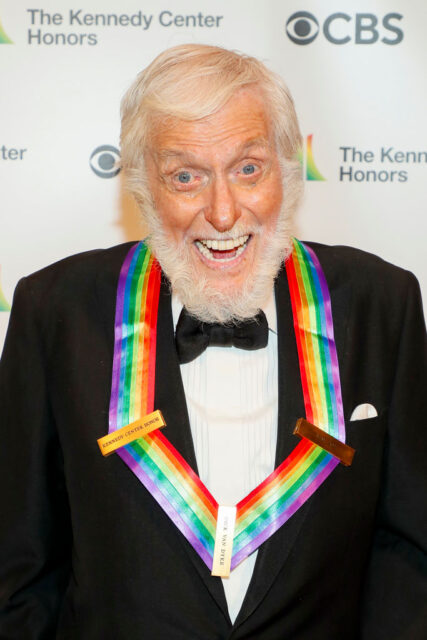 Dick Van Dyke standing on a red carpet